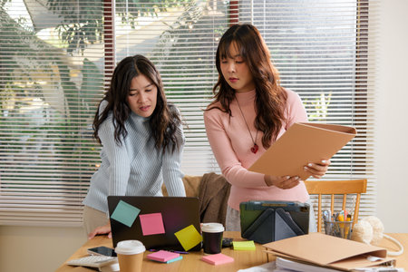 Young business people busy meet in office, team work consult financial matters, collaborating on important projects, achieving professional goals, showing dedication for company success at workplace.の写真素材