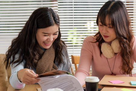 Young busy people meet for business work in office, financial team consults documents, collaborating on important projects, sharing ideas for success, working hard toward future growth.の写真素材