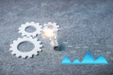 Data driven business marketing strategy concept analytics innovation process and decision making with glowing light bulb near white gears and blue graph showing market results.の写真素材