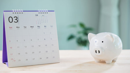 Save money plan and piggy bank plus calendar help manage financial growth, investors set retirement goals for insurance date and tax payment to track saving progress monthly.の写真素材