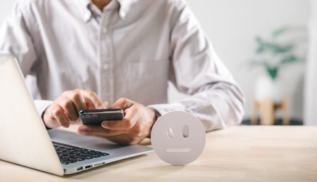 Survey captures neutral customer feedback, man uses smartphone and laptop, diligently evaluates...