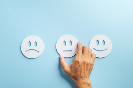 Customer feedback concept, hand selecting neutral face from range of happy neutral and sad...