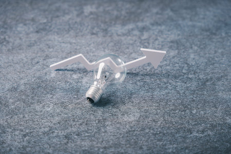 Innovation thinking concept with lightbulb and white zigzag arrow on gray background represents business success, providing professional growth through strategic design insight.の写真素材