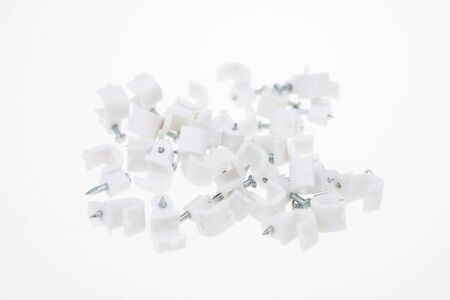 Cable clip round white with a nail on white backgroundの写真素材