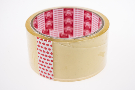 Roll of clear transparent sticky tape isolated on whiteの写真素材
