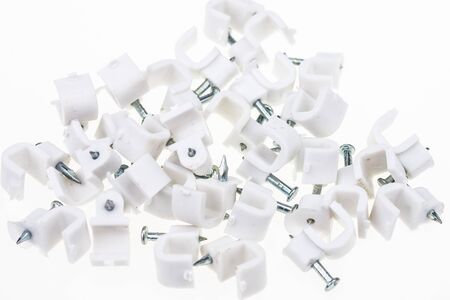 Cable clip round white with a nail on white backgroundの写真素材