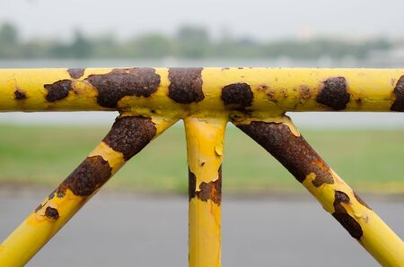 rusty yellow fenceの写真素材