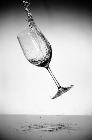 glass and water splash in black and whiteの写真素材