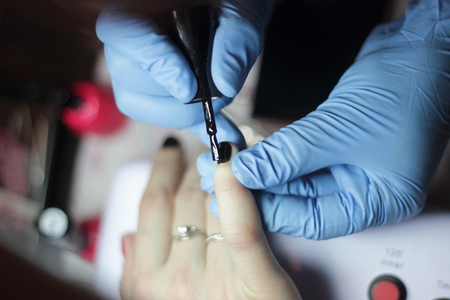 manicure female hands in beauty salon, close up
