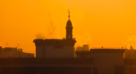 Muslim mosque in foggy evaporation at sunset, background, frozen duskの写真素材