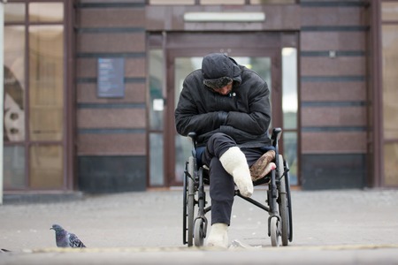 Russia, Kazan 14 september 2016, dowmtown - Disabled homeless man on a wheelchair begging for money - drunk beggar sleeping, telephotoのeditorial素材