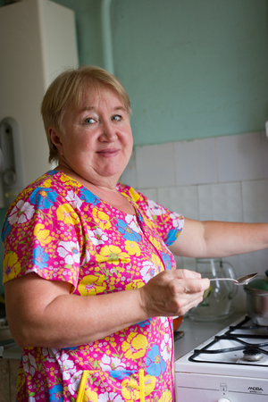 Senior woman on the kitchen At Home, family conceptの写真素材