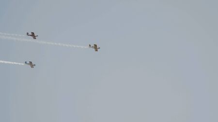Three small airplanes for agricultural industry flying in the sky, telephoto shot
