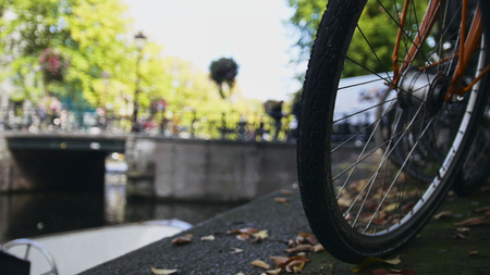 View of wheel  bicycle on the Amsterdam canal, sunny european autumnの写真素材