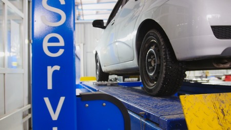 Auto wheel alignment in service, car preparing for professional diagnosticsの写真素材