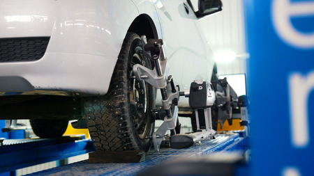Lifted car in professional service - the collapse of convergence - process repairingの写真素材