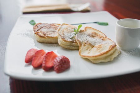 Hot pancake with strawberry and sauce - fritters of cottage cheese, taste breakfastの写真素材