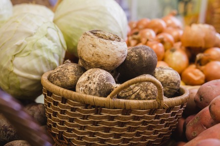 Vegetables in supermarket - turnips, onion and cabbage at grocery storeの写真素材