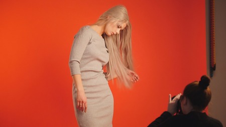 Photographer and blonde model in studio - Fashion back stageの写真素材