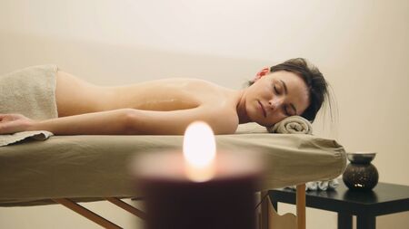 Oil relax massage - half nude young female on parlor, spa concept