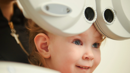 Healthcare - little cute girl in ophthalmologist roomの写真素材