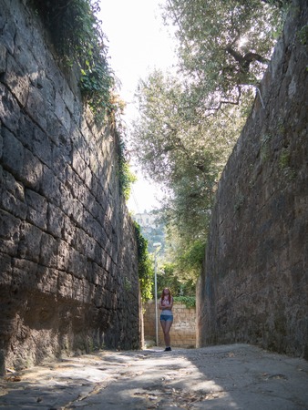 Portrait of beautiful girl posing in garden at street of Sorrento, Italyの写真素材