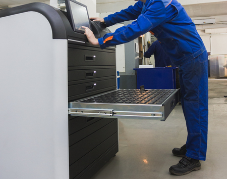 Automatic labour - Industrial worker operating near metal machining industry