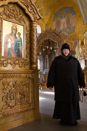 Kazan, Russia, 9 february 2017, golden domes in Zilant monastery - - a nun - Mother Sergiya in orthodox church near iconsのeditorial素材