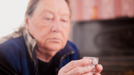 Tablets in the hands of an elderly womanの写真素材