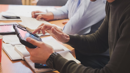 Office: stuff discussing financial report using data and gadget