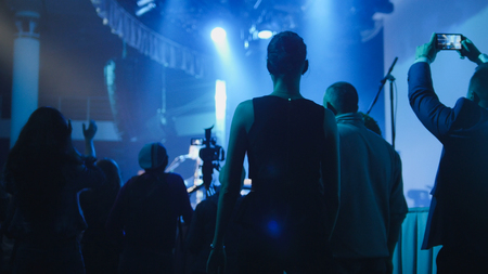 People stand near the stage during a concertの写真素材