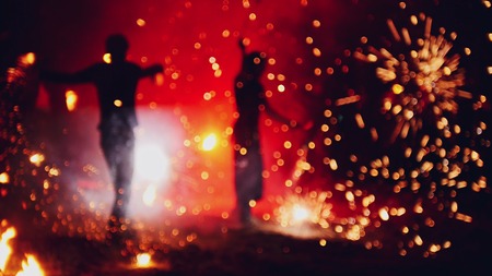Blurred fireworks on beach at night fire-show performanceの写真素材