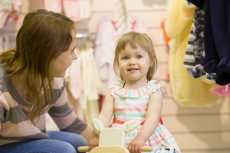Mother and daughter in store of children clothingの写真素材