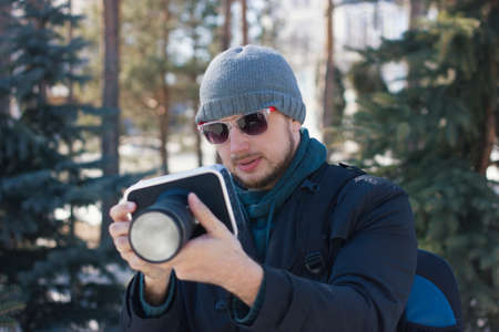 Videographer with the camera in the winter forestの写真素材