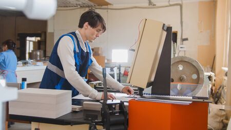 Press operator works in a typographical machine