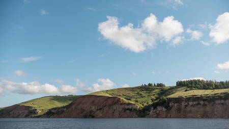 Summer landscape - european river, blue sky and green meadow on coastの写真素材