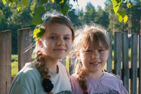Two pretty teenagers girls friends in the park - summer outdoorの写真素材