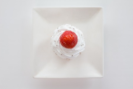 Capcakesweets - cake with strawberry on white plate - top viewの写真素材