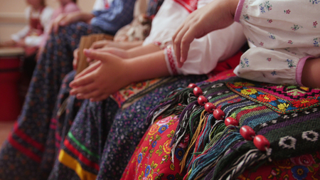 Russian folk musical group - women in traditional costumes sitting on benchの写真素材