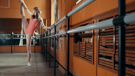 Graceful girl ballerina practicing in the Studio, elements of acrobaticの写真素材