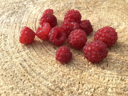 Ripe fresh raspberries on a wooden backgroundの写真素材