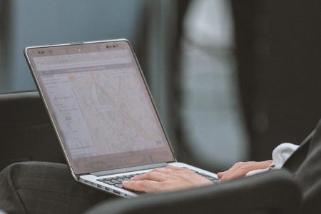 Businessman working on a laptop at seminar - close upの写真素材