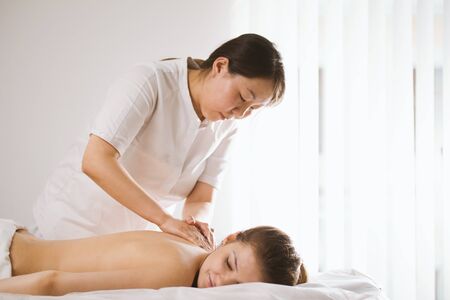 Tibetian massage in spa salon for young womanの写真素材