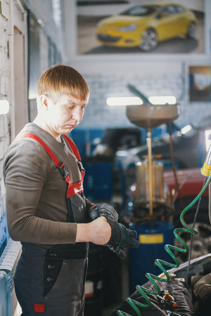 Mechanic works with voltmeter - car electrics - electrical wiringの写真素材