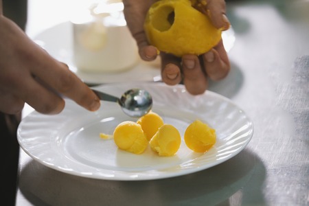 Chef makes potato balls for salad in commercial kitchenの写真素材