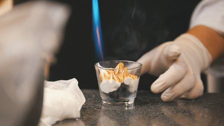 Process cooking of meringue - chef use fire for decorates dessertの写真素材