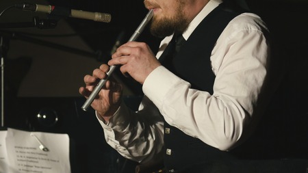 Bearded man plays pipe on the stageの写真素材