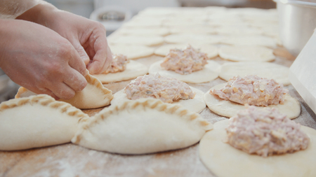 Cooks is making bakery products by hands