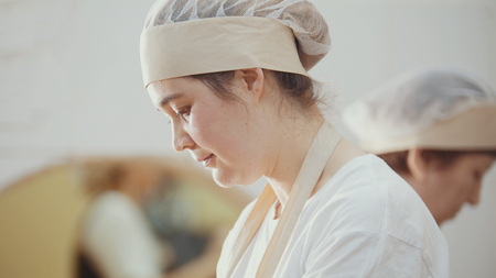 Women cooks is working on the kitchenの写真素材