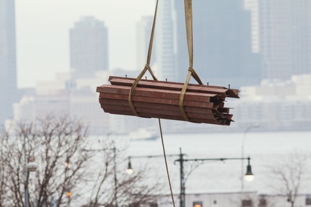Metal fittings on the building crane on the background of the urban landscapeの写真素材